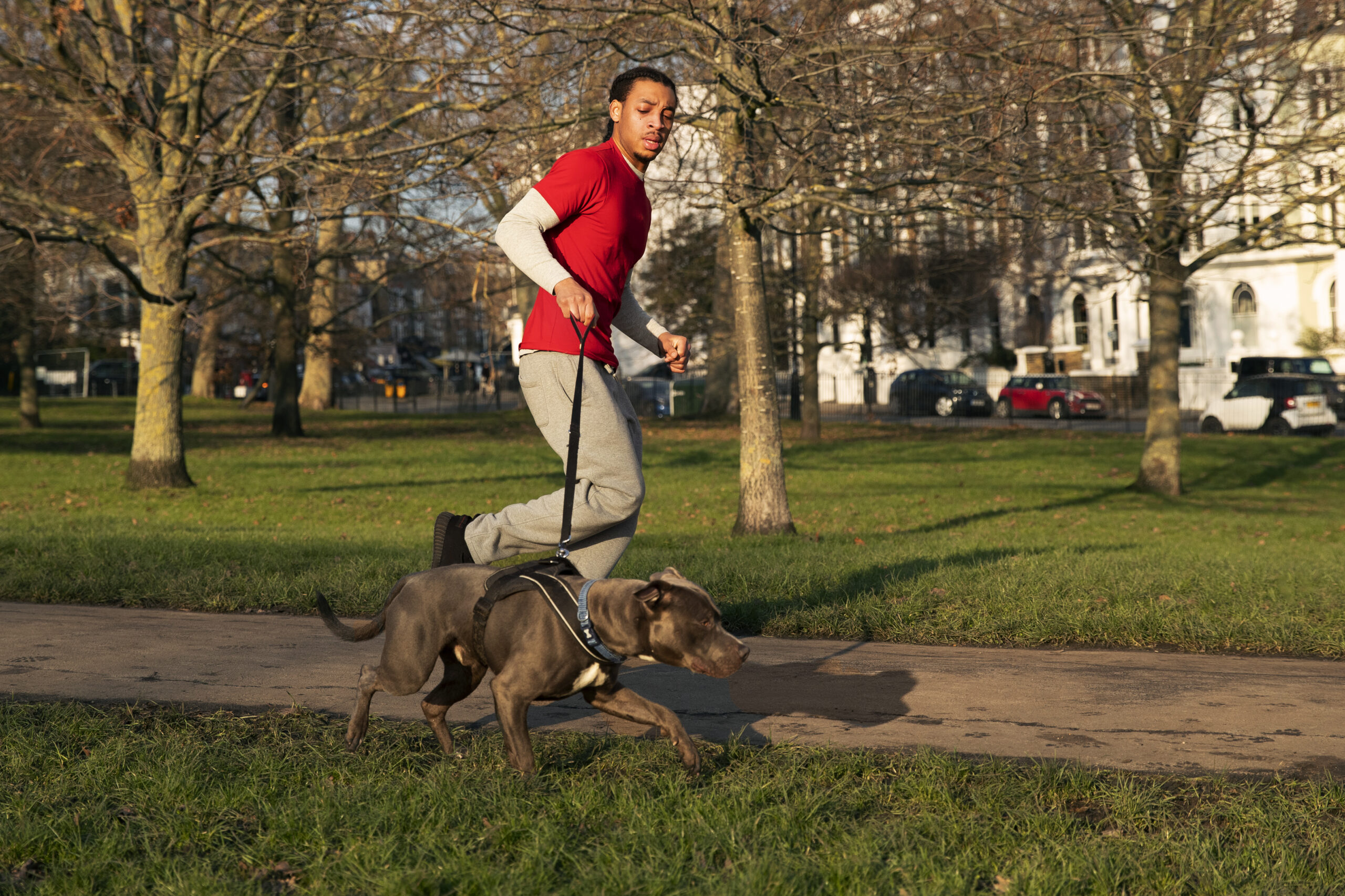 full-shot-man-running-with-dog-outdoors