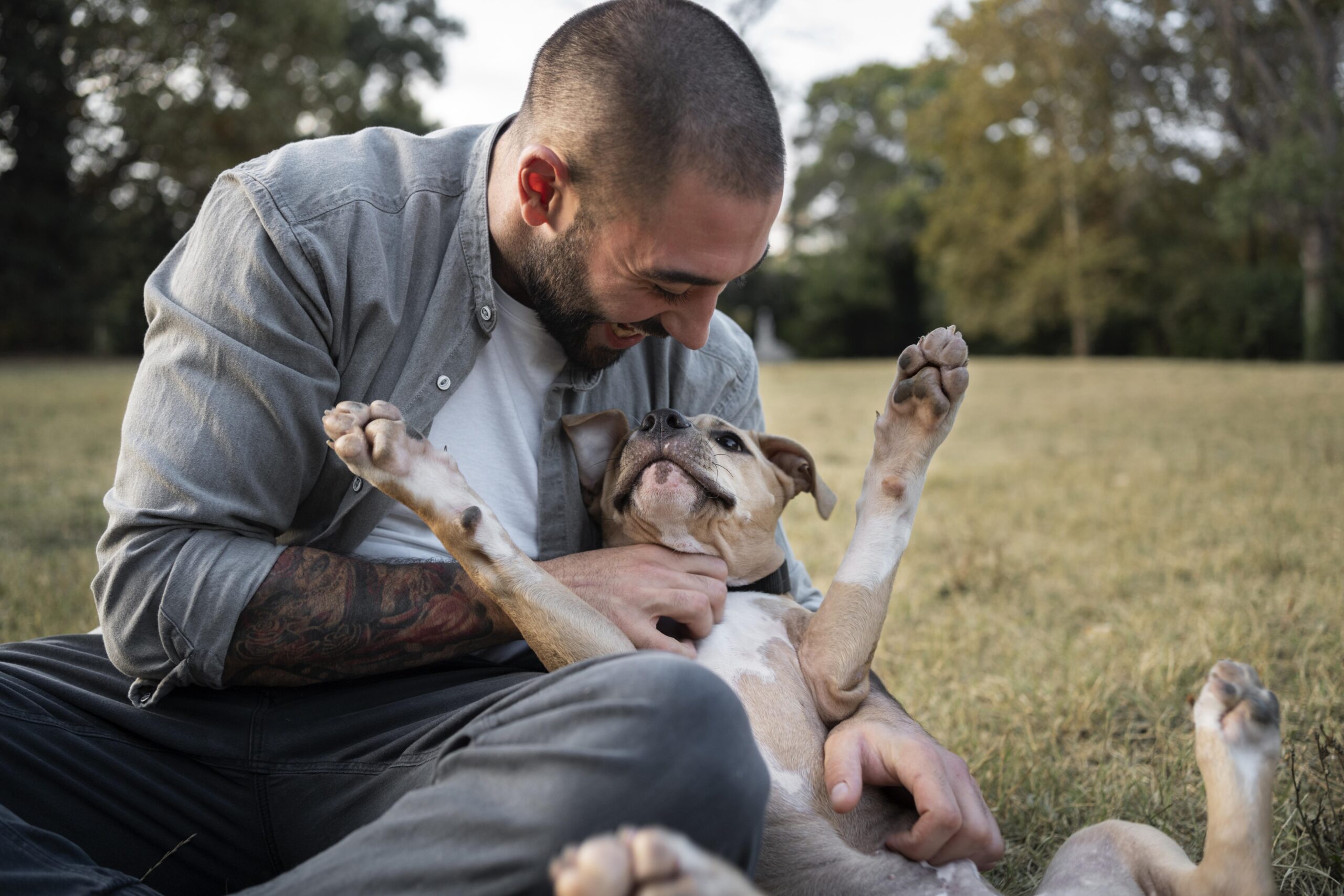 man-hugging-his-friendly-pitbull